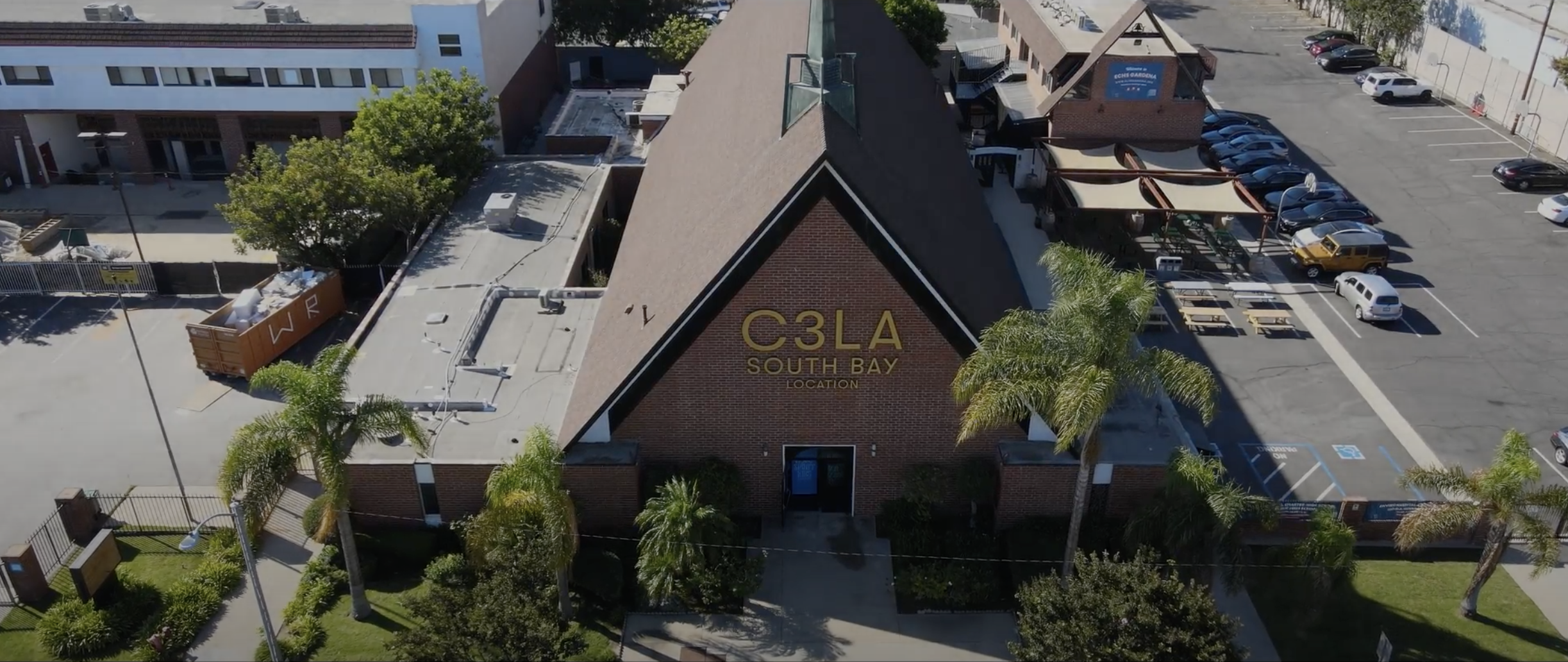 A building with a roof and a C3LA sign on it
