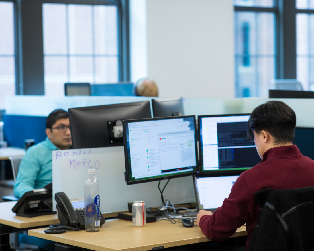 Two associates in the office using open source solutions on their desktop computers